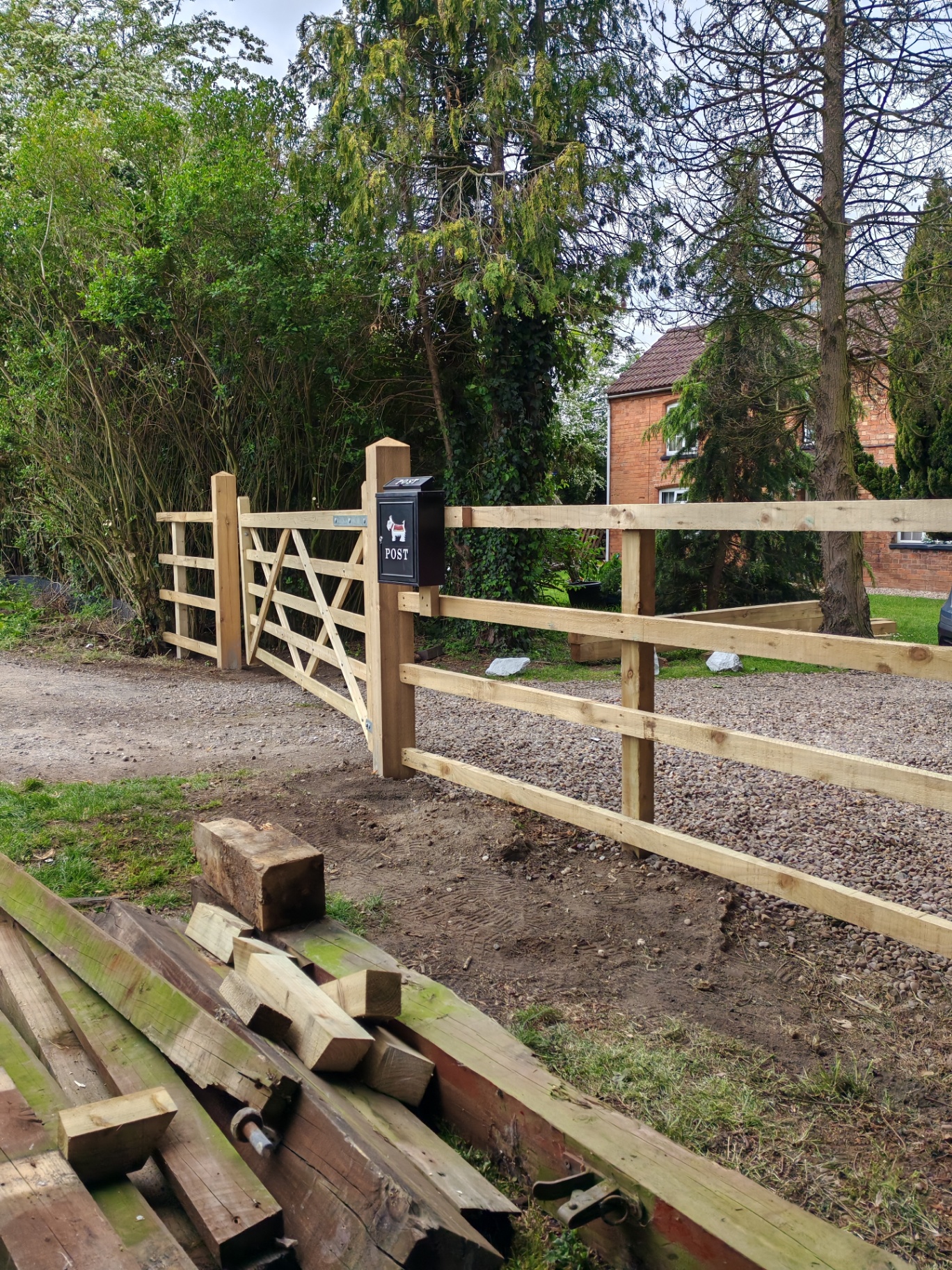 Five-bar gate and fence with post box — angled view